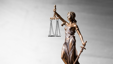 a statue with a scale in hand representing equlity of some kind
