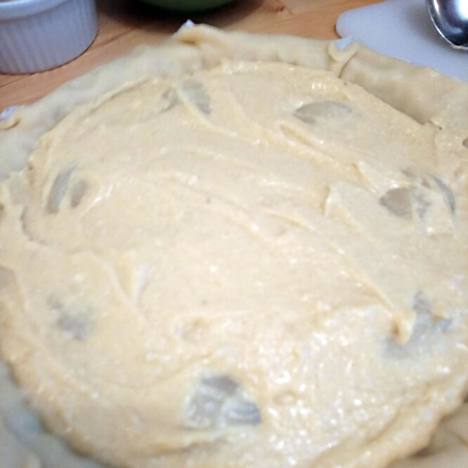 Pour the mix on top of the pear slices, onto the pastry and spread well.