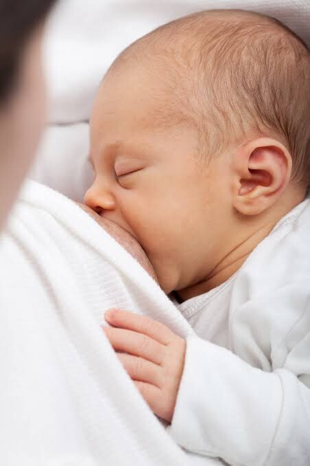 A Mother Breast feeding her child