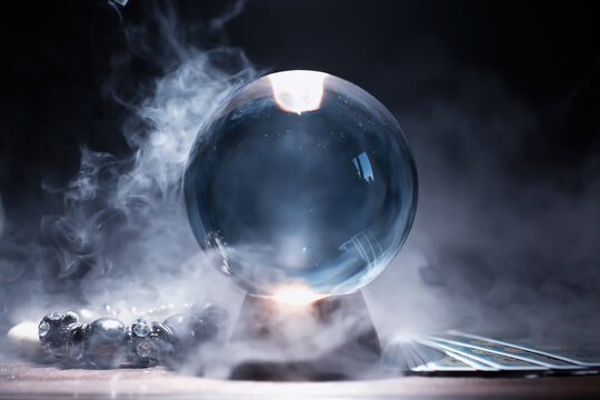 Crystal Ball on a Stand with Smoke Surrounding It.