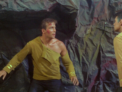 Captain Kirk with torn uniform - still photo from Star Trek episode