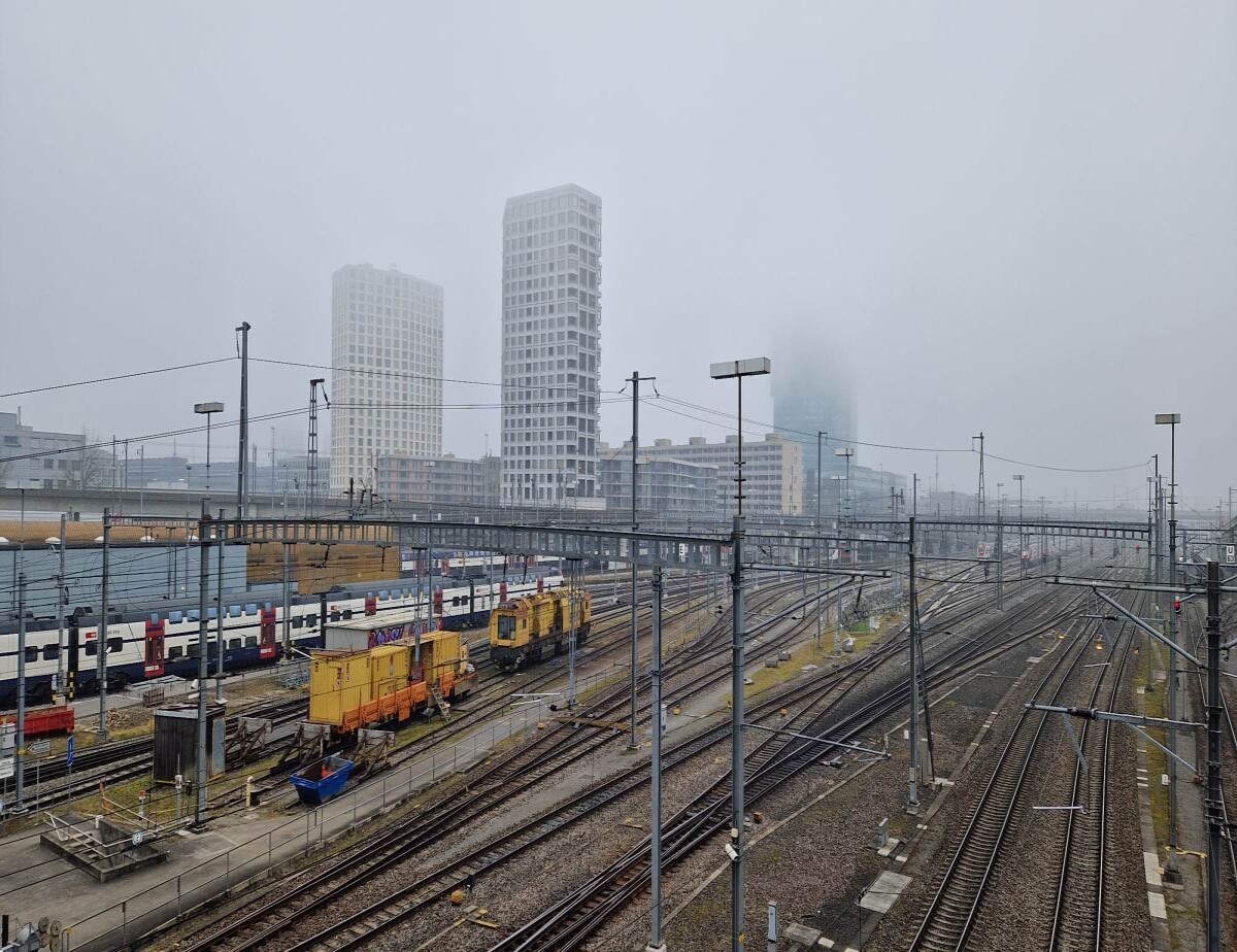 gray day walking over a bridge that crosses over the train tracks