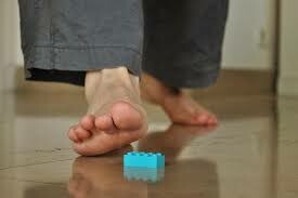 Stepping on a LEGO brick - Barefoot walking on top of a brick
