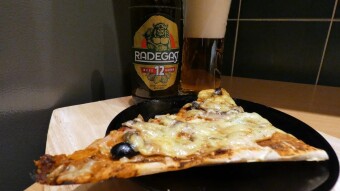 Homemade rich pizza and Czech light beer Radegast Ryze Hořká 12°