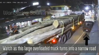 Oversized truck turns on a narrow street and swipes away a small autorickshaw