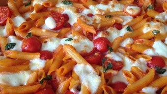 Creamy pasta casserole with tomatoes and mozzarella