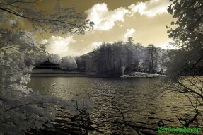 Infrared Photography - Sun rising over the mountains by the lake