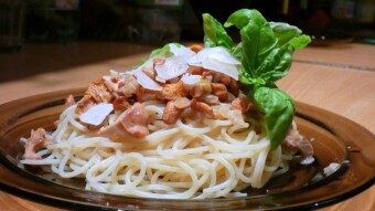 Chanterelles in cream sauce, with pasta, with Parmesan flakes, and lemon basil