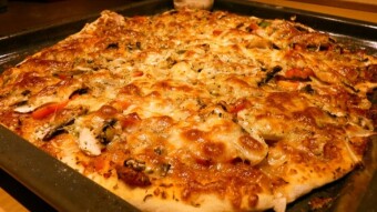 Homemade rich pizza with two cheeses, sirloin, salami, mushrooms, olives and pepper