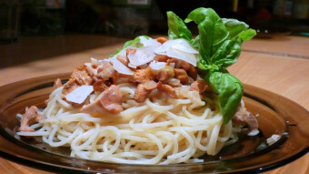 Chanterelles in cream sauce, with pasta, with Parmesan flakes, and lemon basil