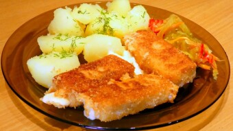 Breaded cheese (Vyprážaný syr) fried with new potatoes and sour vegetable salad