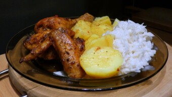 Baked chicken legs and wings in a bag with white radish salad