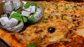 Baked champignons with herbs and ricotta cheese and homemade pizza with salami and mushrooms