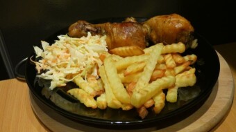 Chicken sticks in a bag with fries and coleslaw