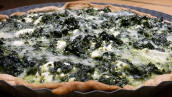 Homemade tart with spinach and feta cheese salad