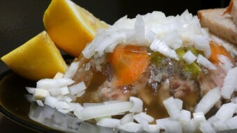 Pork leg and pork knuckle jelly with green peas, egg, onion, and lemon