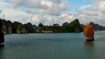 A junk sailing among limestone karsts