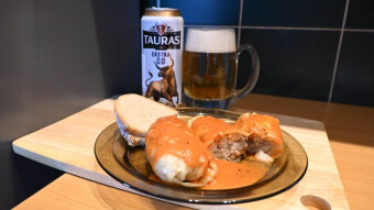 Lithuanian Tauras beer and cabbage rolls with tomato sauce