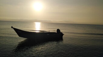 Sunrise, & The Fishing Boat Abandoned among Motionless Waters