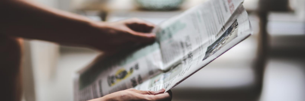 Person Reading Newspaper