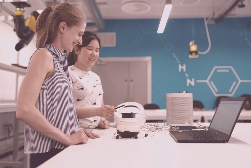 two young women working in tech