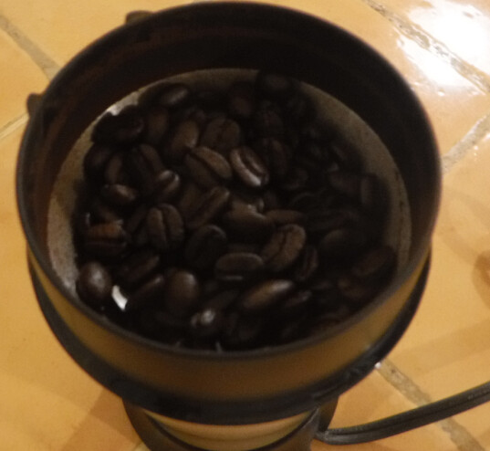 Coffee beans in a coffee grinder