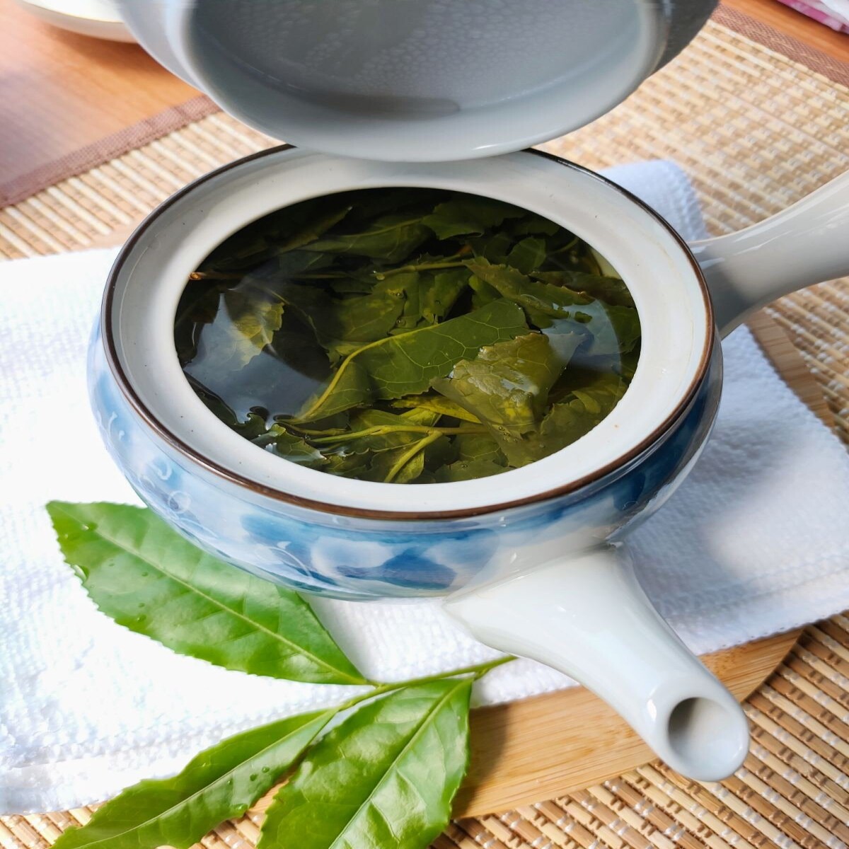 Teapot with tea leaves steeping