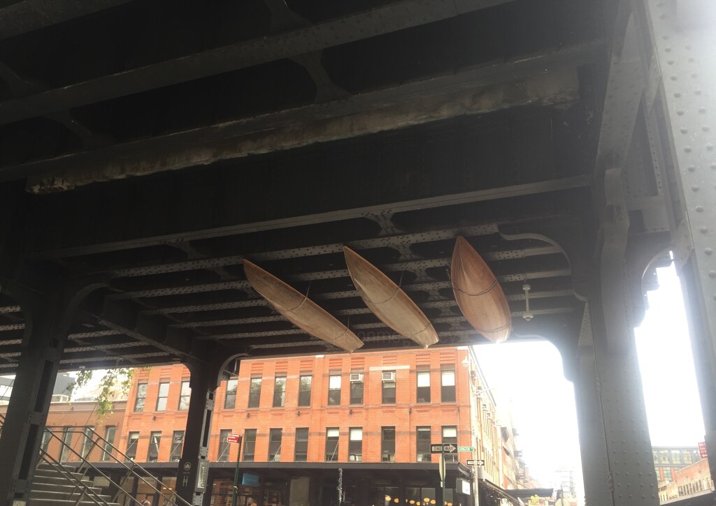 Canoes underneath elevated train tracks