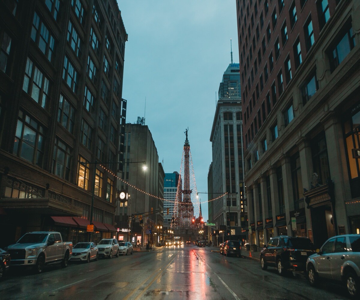 soldiers and sailors monument in downtown indy from a wet street on a rainy day