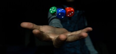Man's hand with three dice hovering above it.  Photo by El Pepe on Unsplash