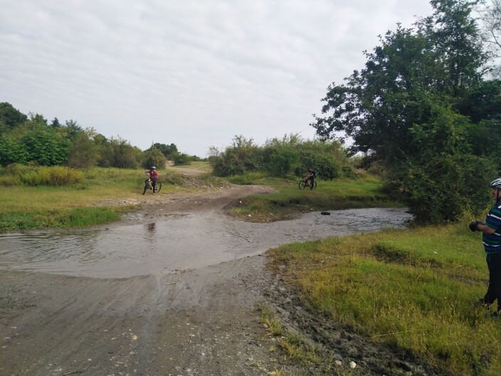 Crossing the Bike Through Water Pits