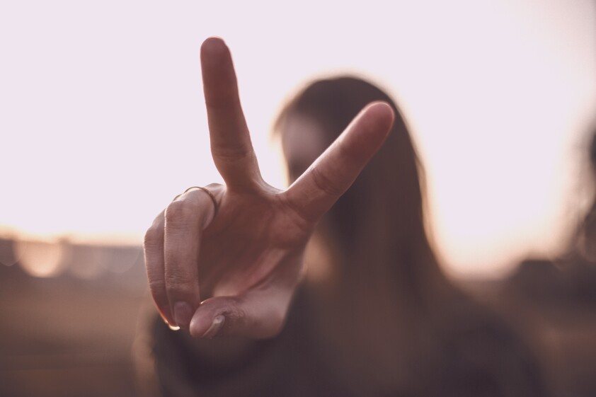 woman doing the peace sign