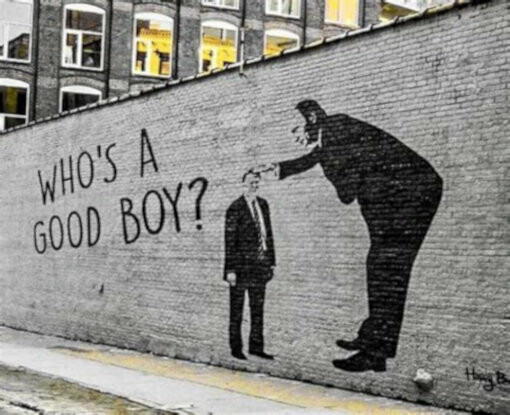 photo of graffiti on a brick wall depicting a boss patting the head of a man in a suit and asking