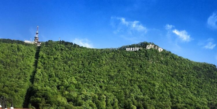 On the left side you can take the cable car up to Brasov sign