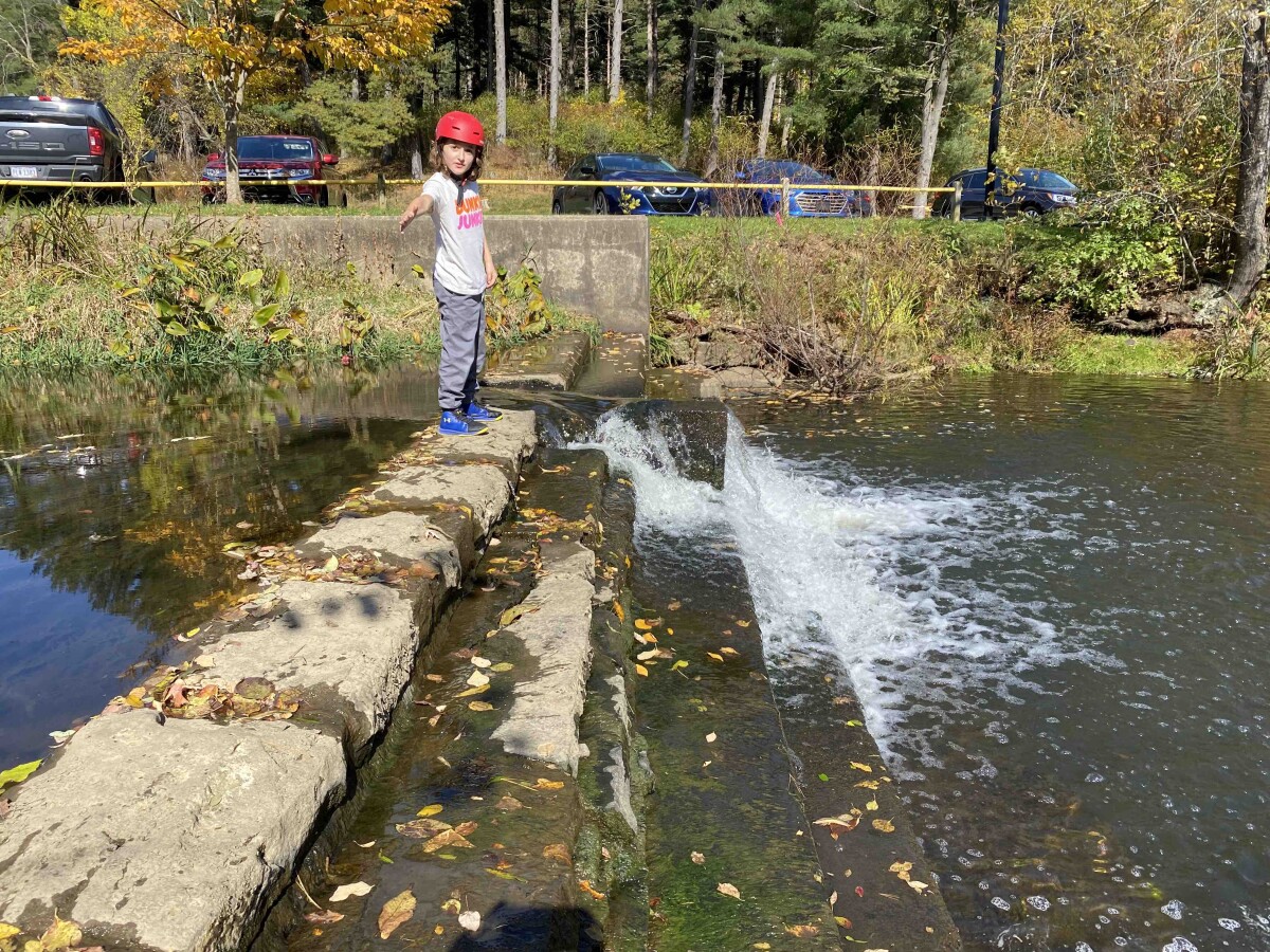 My son playing on a waterfall at a park