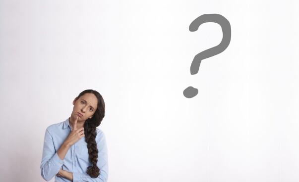 a women thinking beside a question mark