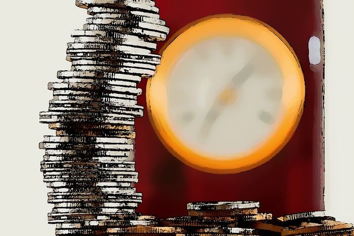 a stack of coins, with a clock in the background