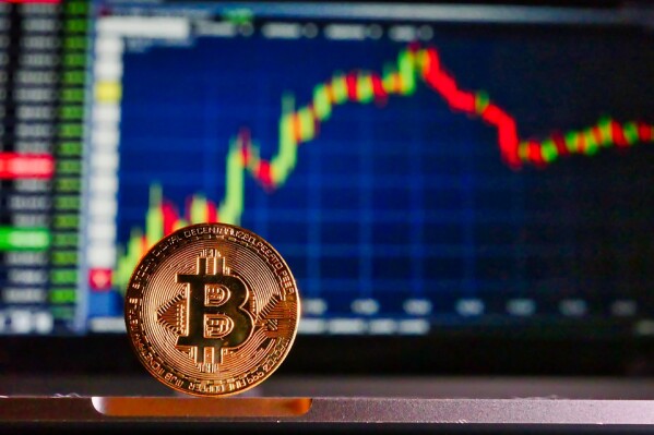 bitcoin in front of cryptocurrency trading platform
