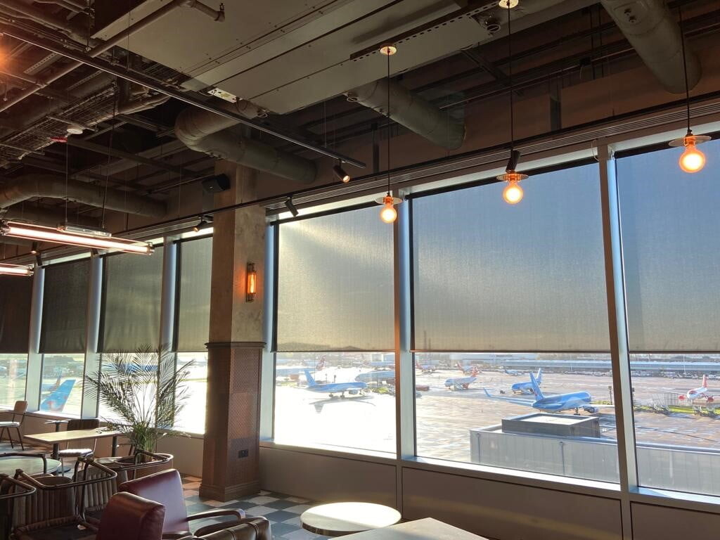 powered roller blinds at half shade on restaurant