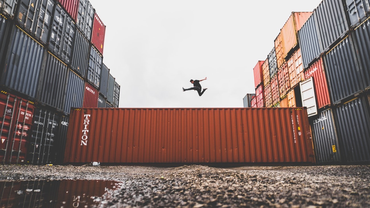 Man Jumping on Intermodal Container