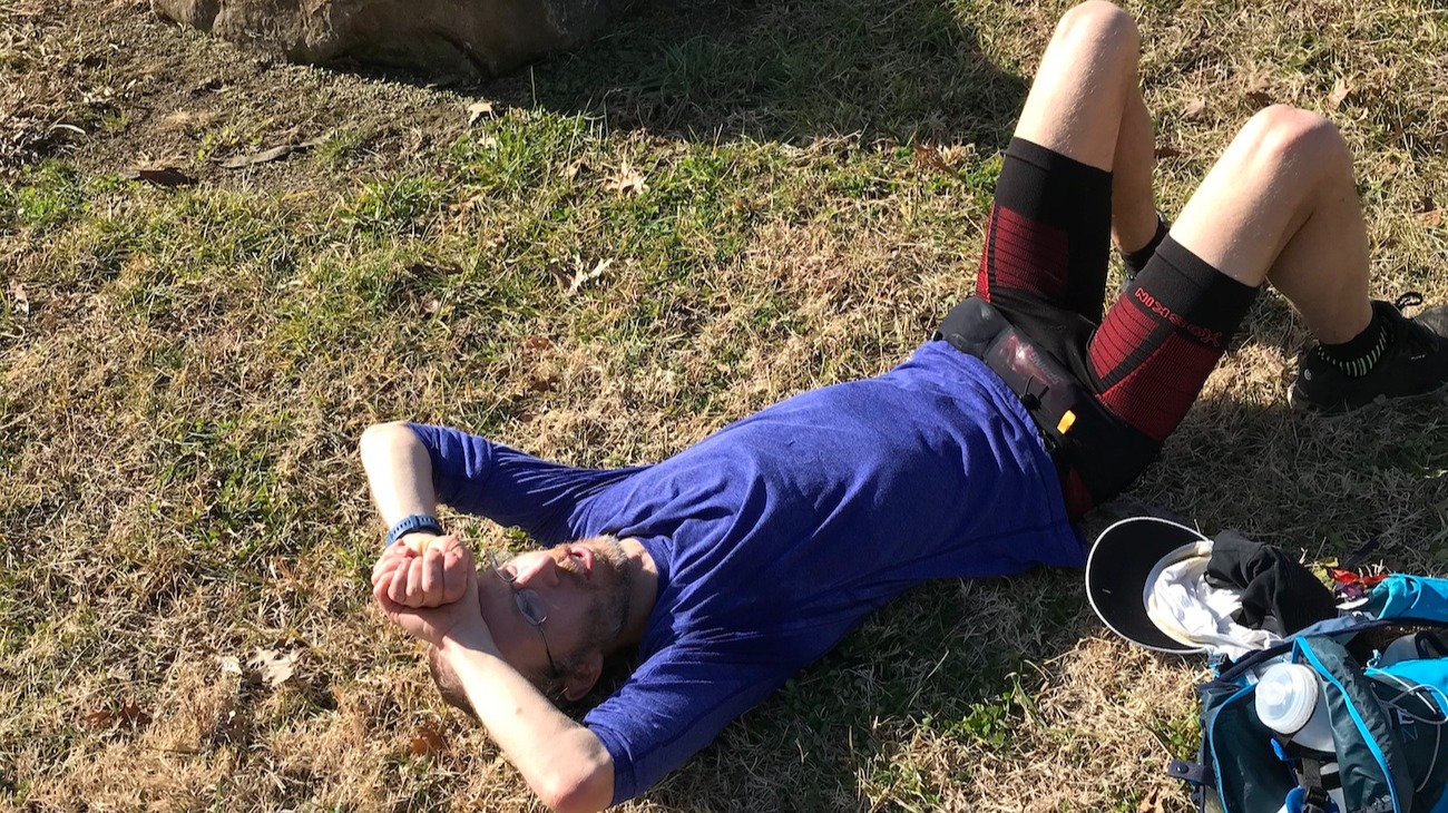 Completely worn out and laying on the grass after finishing the unsupported FKT