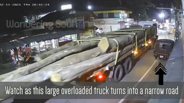 Truck crashes while turning on narrow street