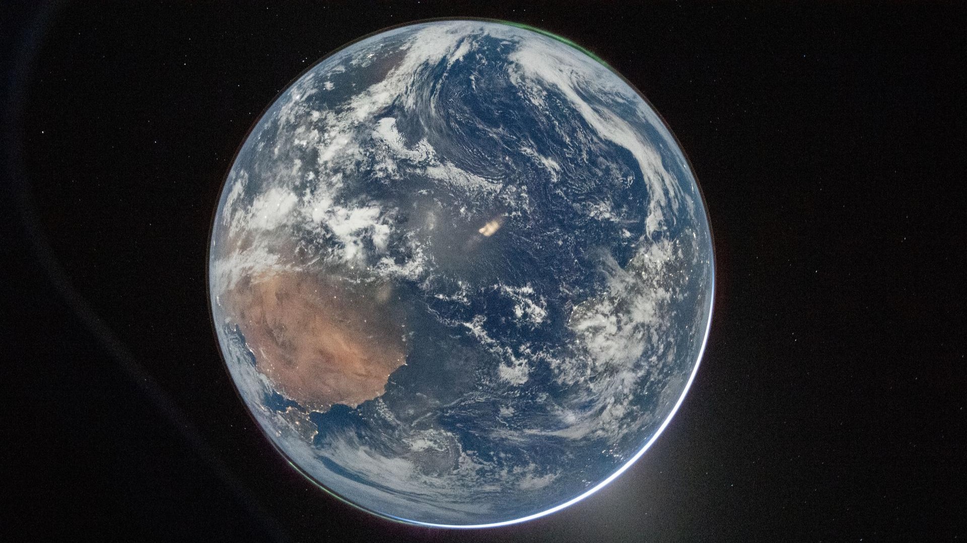 A view of Earth taken by NASA astronaut R. Wiseman from one of the Orion spacecraft’s window after translunar injection burn.