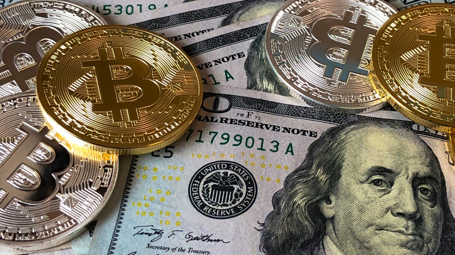 https://www.pexels.com/photo/bitcoins-and-u-s-dollar-bills-730547/
