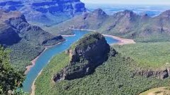 The three rondavels tower over Blyde River Canyon, ancient stonegiants wrapped in green, guarding Mpumalanga's wildest view.