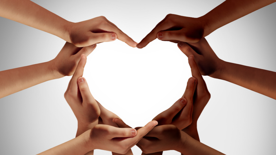 Hands in the shape of a heart representing love in all colours