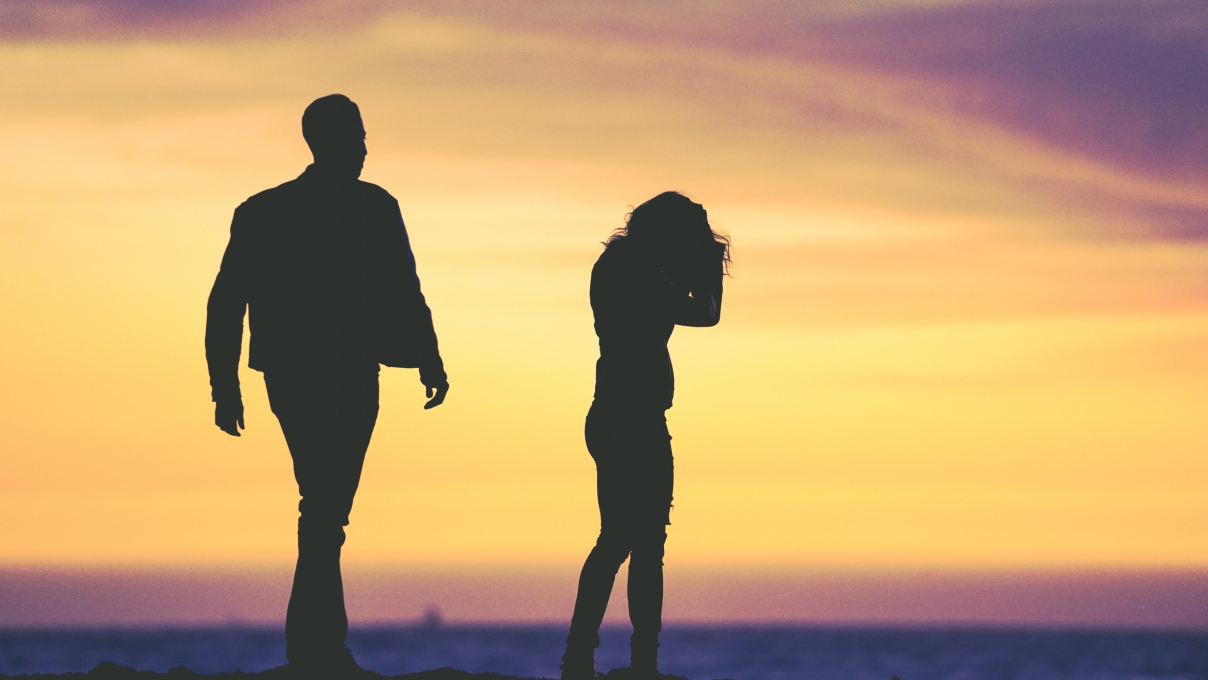 Man walking towards a woman in silhouette