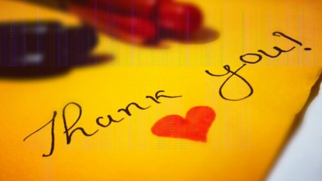The thumbnail says thank you which is written with a black ink on a golden-brown paper. It also has a red love shape.