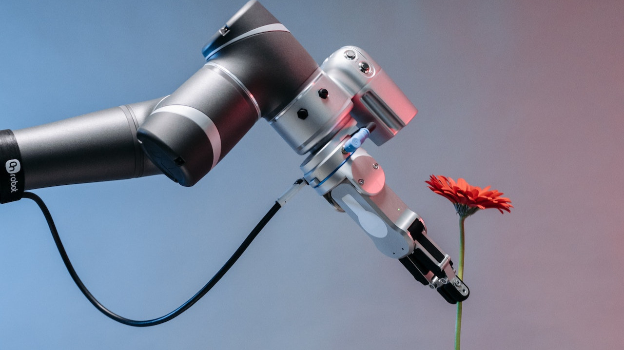A robotic hand holding a flower