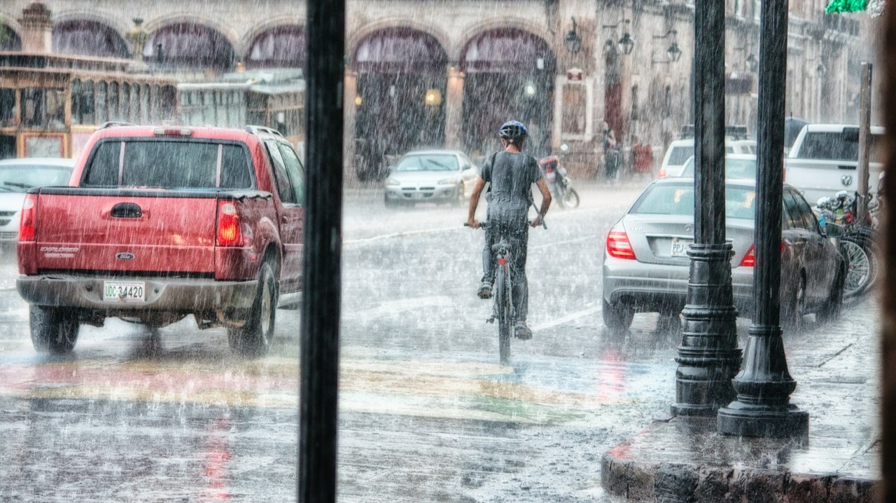 Person riding a bicycle on a rainy day
